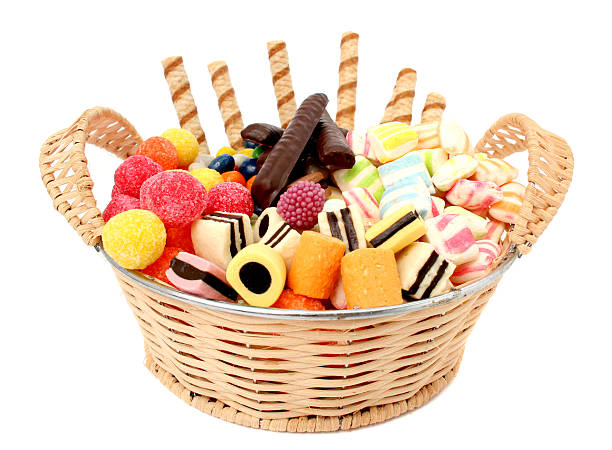 Basket with various sweets and the cookies, isolated
