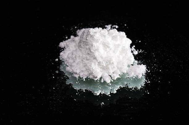 istock Cocaine drugs heap on a black mirror, close up view 137949712