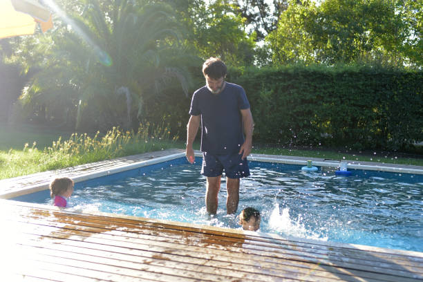 istock father with his children in the pool 1379505127