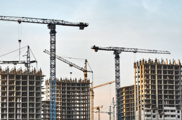 istock Multistory buildings and cranes at blue sky background 1379509318