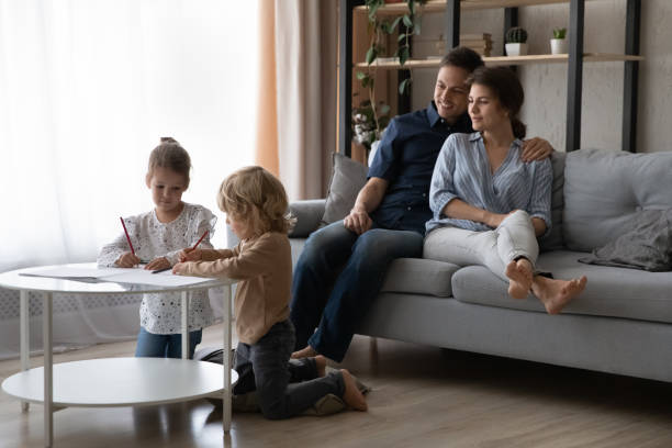 istock Relaxed happy millennial mom and dad resting on couch 1379514555