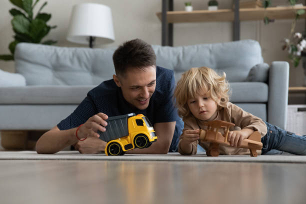 istock Happy dad and preschool son kid lying on heating floor 1379514578