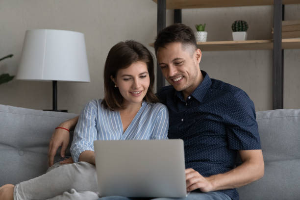 istock Smiling relaxed married couple using ecommerce app for online shopping 1379515659