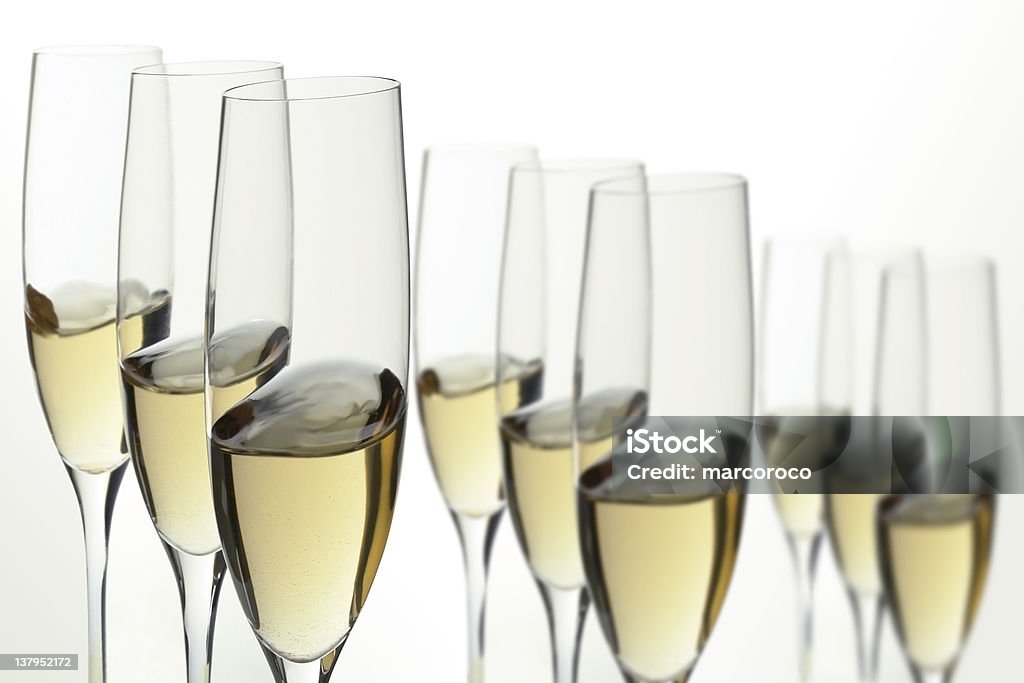 Nine white wine glasses Nine wineglasses of the white wine in the movement.Close up. Alcohol - Drink Stock Photo