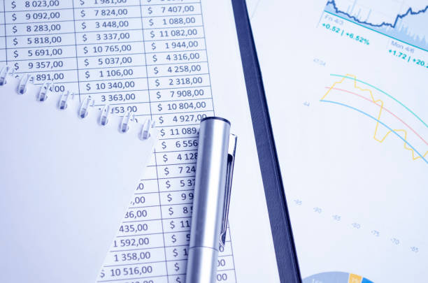 istock data analyzing in stock market: on the quotes prints, and a pen 1379568508