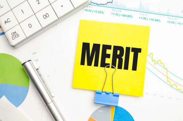istock Notepad with text merit on the business charts and pen,business 1379568520