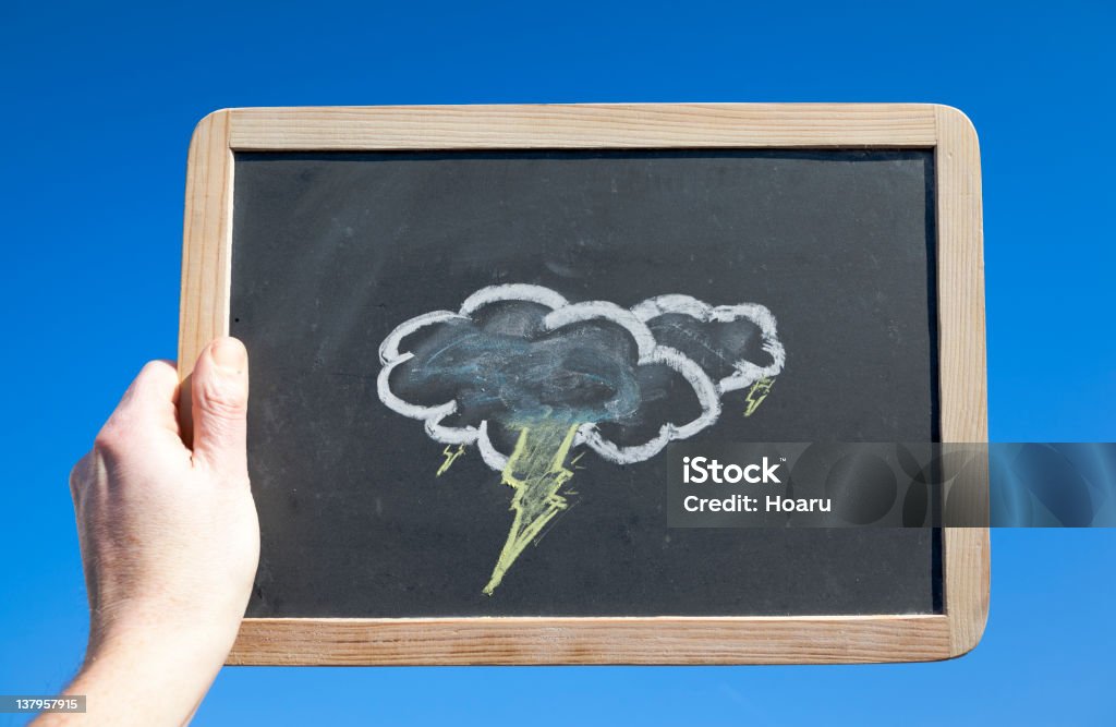 Stormy Clouds on Blackboard Against Blue Sky. Weather Concept Black Color Stock Photo