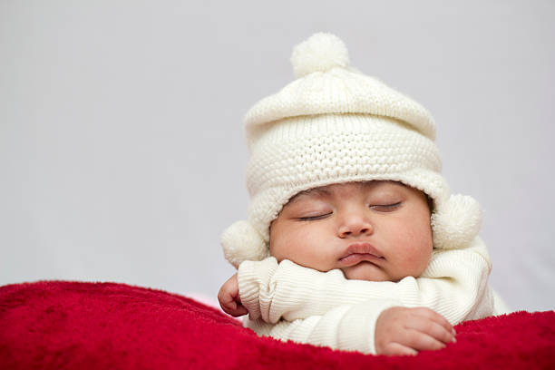 istock Baby Girl Sleeping with off white Hat 137958207