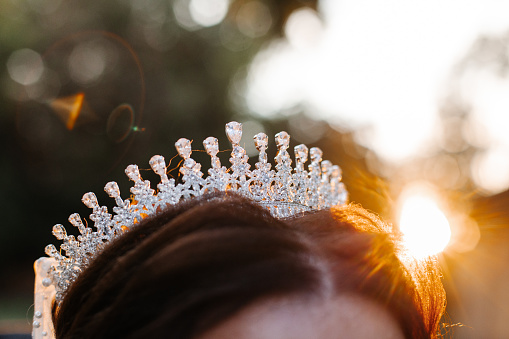 A crown on the bride's head at sunset.