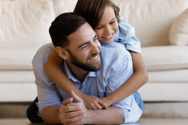 istock Happy millennial dad relaxing on heating floor at home 1379620893
