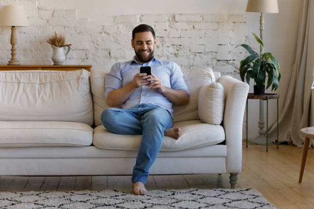 istock Happy cheerful smartphone user chatting online, reading text message 1379620915