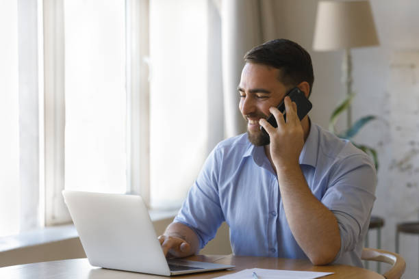 istock Happy busy professional man talking on telephone 1379621246