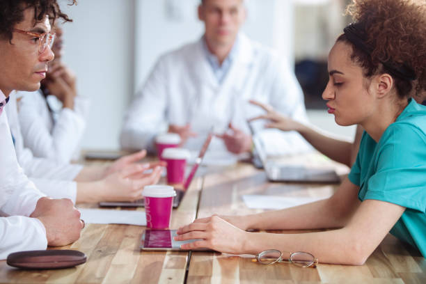istock During a coffee break, a group of medical workers sit at a table and chat. 1379623206