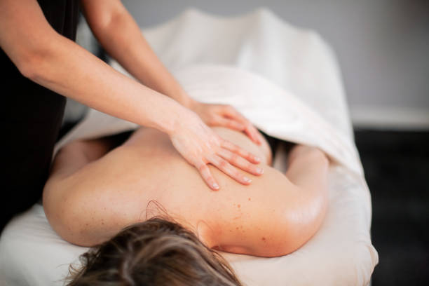 istock Physical Therapist Massaging Female Patient 1379657387