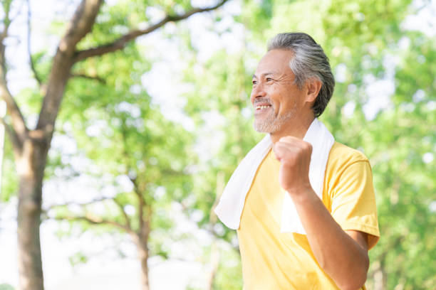 istock elderly man exercising in the park 1379657393