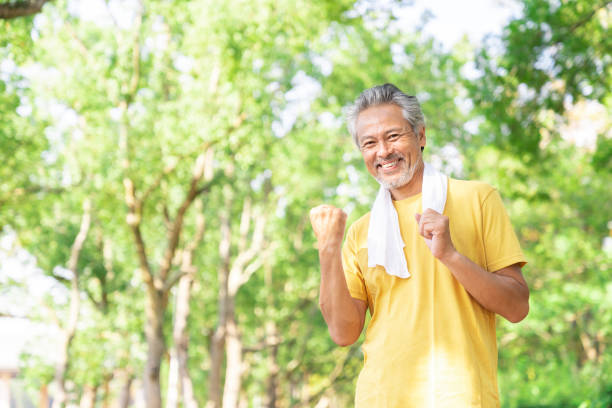 istock elderly man exercising in the park 1379657914