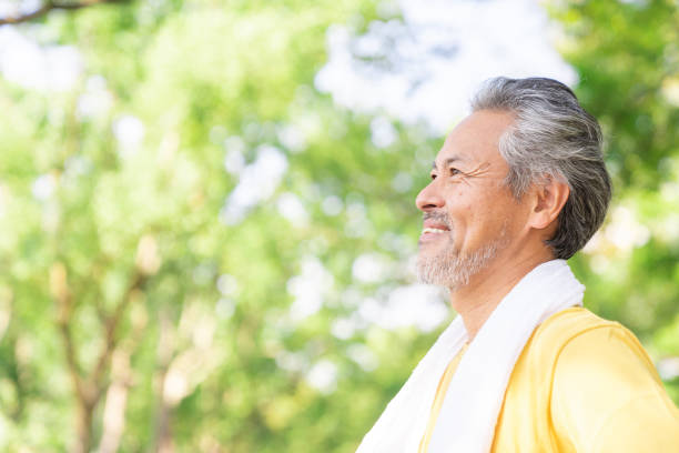 istock elderly man exercising in the park 1379657922