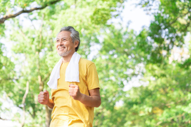 istock elderly man exercising in the park 1379657927