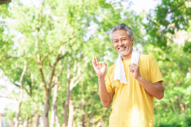 istock elderly man exercising in the park 1379658980
