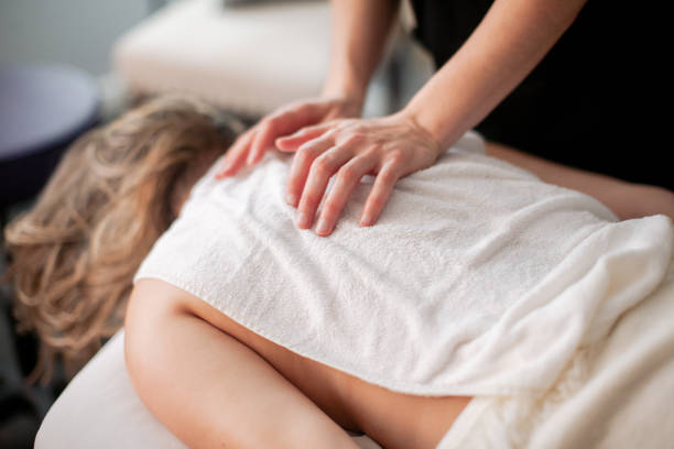 istock Physical Therapist Massaging Female Patient 1379659016