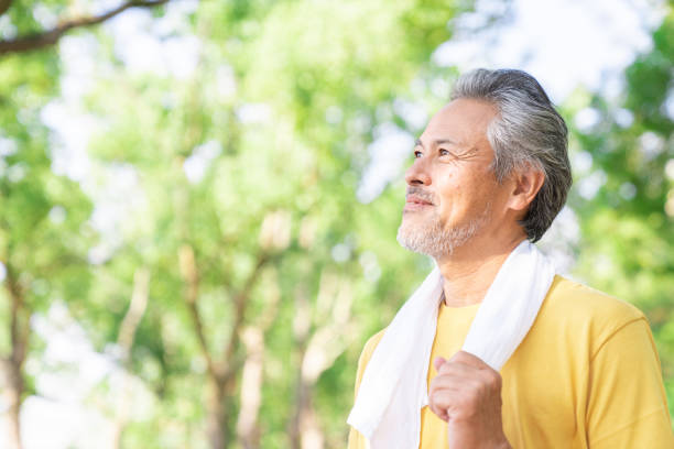 istock elderly man exercising in the park 1379659017