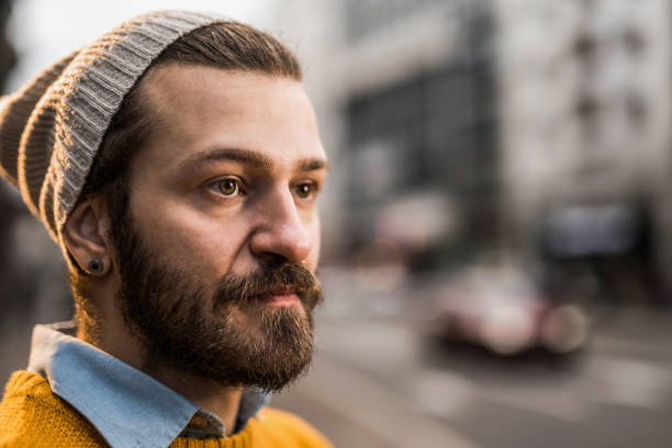 istock Thoughtful man contemplating on city street. 1379663686