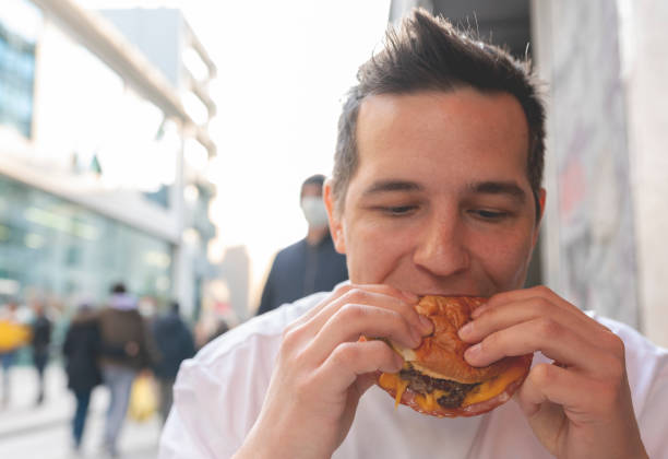 istock Man eating a hamburger stock photo 1379668089