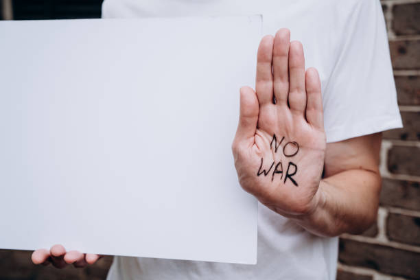 istock No war message written on hand. Russian Ukraine war conflict confrontation protest. Anti war manifestation poster paper mock up 1379684739
