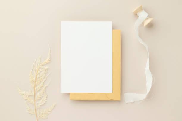 istock Blank greeting card invitation Mockup 5x7 on Brown envelope with dried flowers on beige background, flat lay, mockup 1379752546