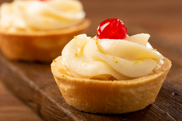 istock Lemon tartlets decorated with cherry. 1379764907