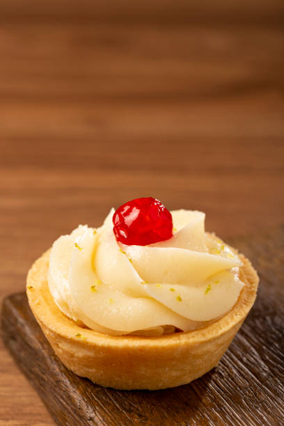 istock Lemon tartlets decorated with cherry. 1379764909