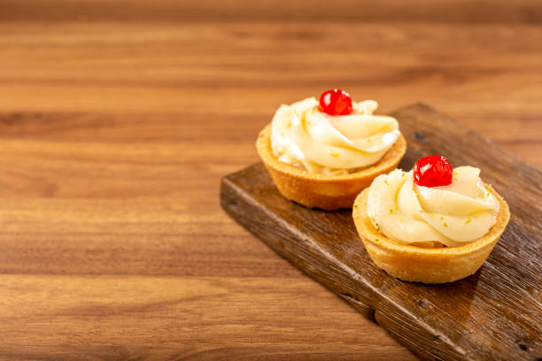 istock Lemon tartlets decorated with cherry. 1379765448