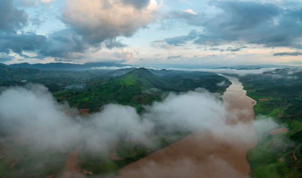 Drone view of Po Ko river with great mountain ranges in clouds - Dak Ha town, Kon Tum province, central highlands Vietnam