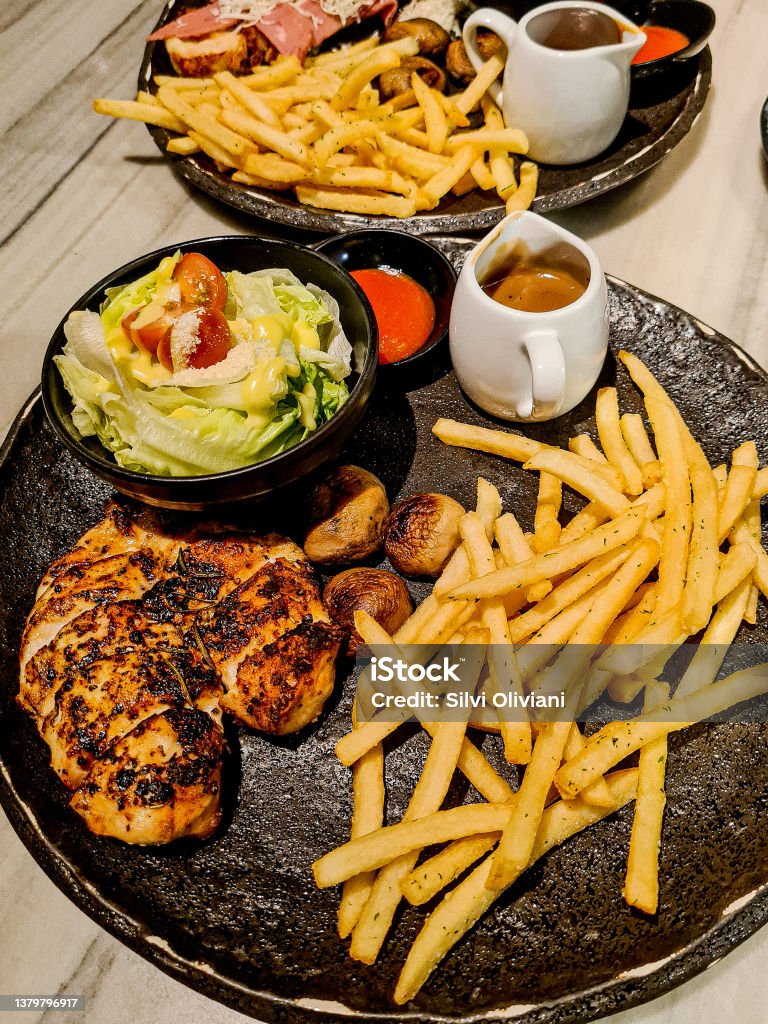 Steak Sizzler Chicken steak with French fries Barbecue - Meal Stock Photo
