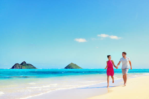 istock Hawaii vacation couple walking on turquoise beach 1379797444