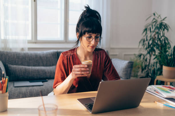 istock Young Woman Working from Home and Drinking Coffee 1379807862