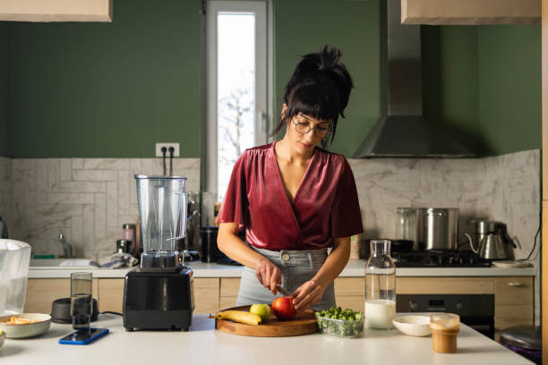 istock Young Woman Preparing Healthy Breakfast at Home 1379807868