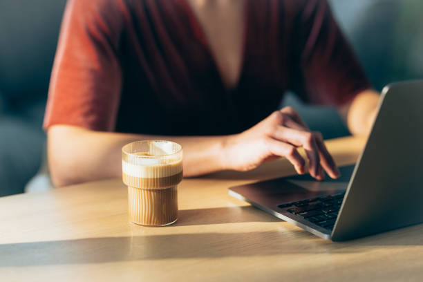 istock Anonymous Woman Working from Home and Drinking Coffee 1379807870