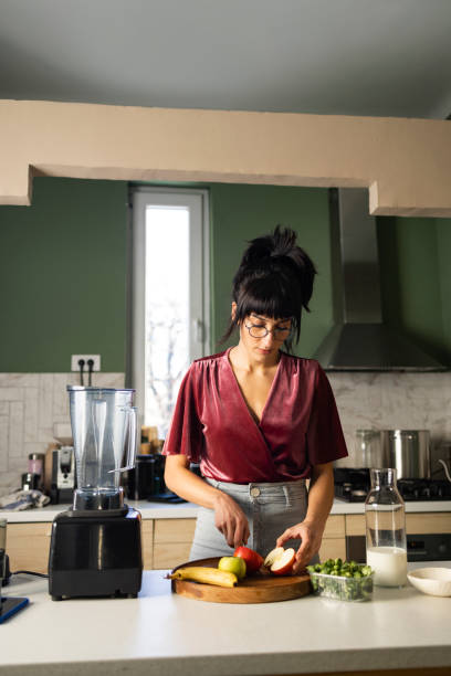 istock Young Woman Preparing Healthy Breakfast at Home 1379807874
