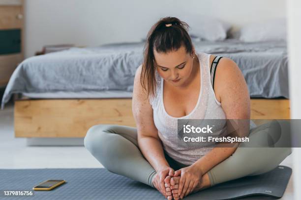 Beautiful Plus Size Woman Doing Yoga In Her Bedroom In The Morning Stock Photo - Download Image Now