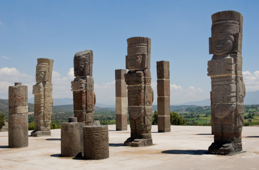 The ruins of an ancient Mesoamerican city from the Toltec empire in Tula, Mexico. The remaining columns of the temple are sculptures of warriors sometimes referred to as the Atlantians.