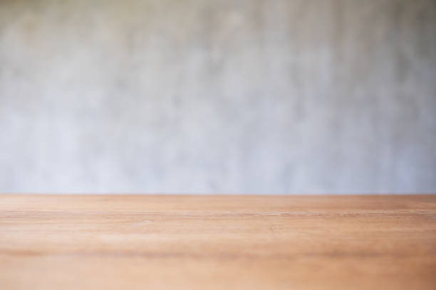 istock Wooden table top with blurred of concrete wall background 1379938735