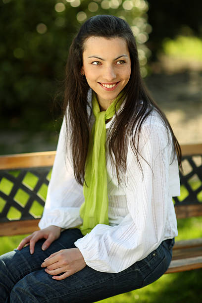 istock Smiling pretty girl sitting on a bench 137993907