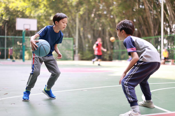istock Two boys playing basketball outside 1379939196