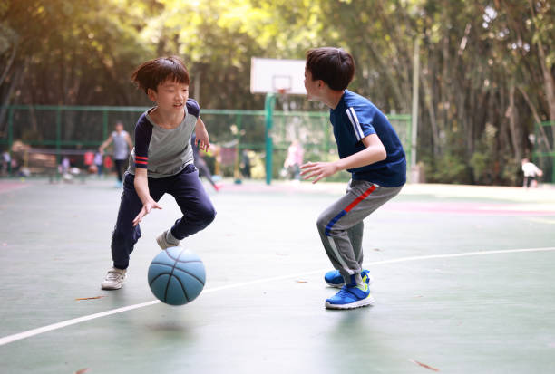 istock Two boys playing basketball outside 1379939242