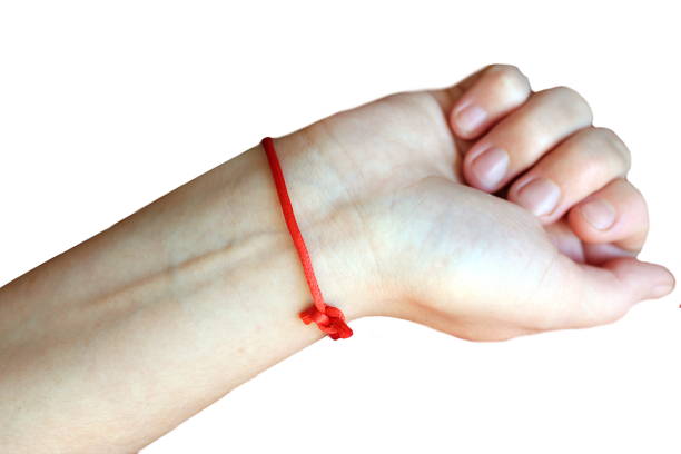 Closeup female hand, woman showing fashionable accessories bijouterie armlet and rings on finger. Beauty red nails.