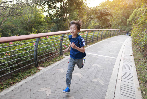istock Little boy running in the park 1379941373