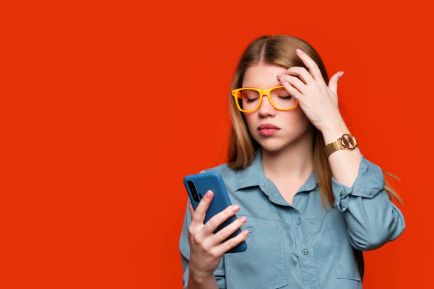 istock Girl in glasses with mobile phone in studio 1379951935