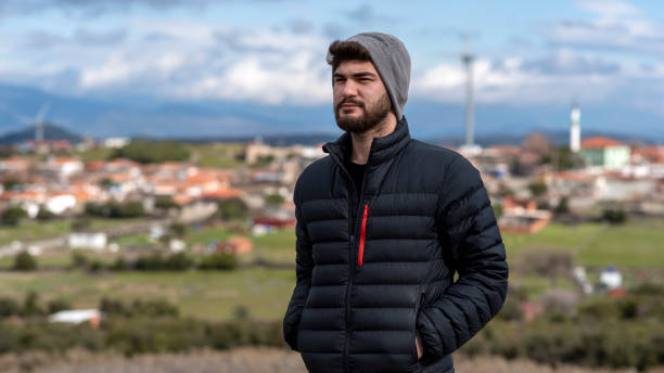 istock serious young bearded man looking away 1379973069