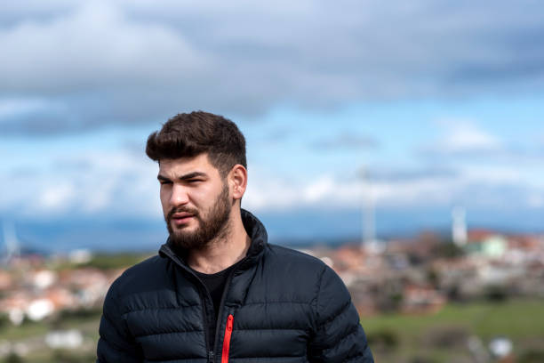 istock serious young bearded man looking away 1379973616